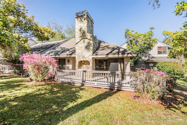 back of property with a lawn and a chimney