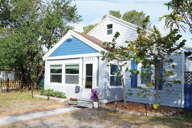 view of front of property featuring fence