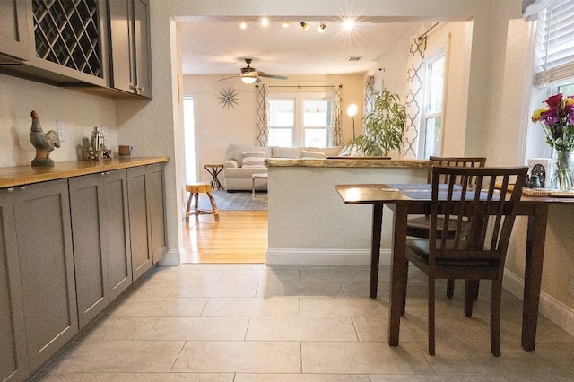 dining area with ceiling fan, light tile patterned floors, visible vents, and baseboards