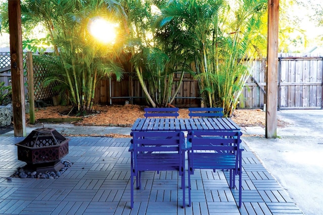 view of patio / terrace featuring a fire pit, outdoor dining space, and a fenced backyard