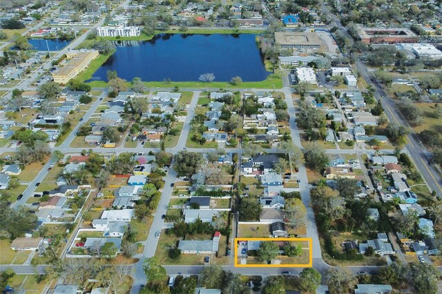 drone / aerial view featuring a residential view and a water view