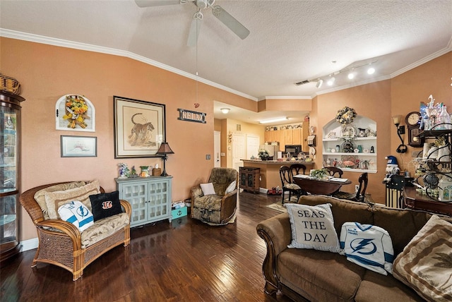 living area with wood-type flooring, visible vents, ornamental molding, and a textured ceiling