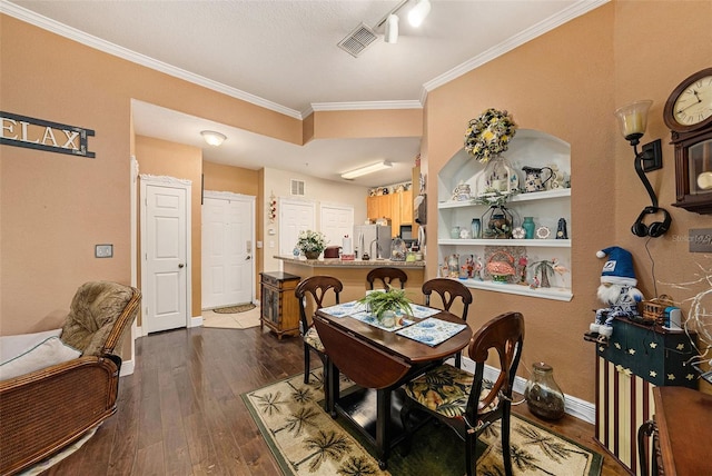 dining space with dark wood-style flooring, visible vents, crown molding, and baseboards