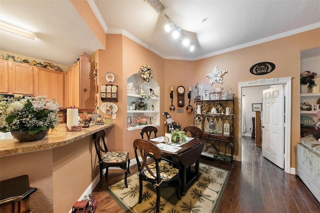 dining space with dark wood-type flooring, visible vents, ornamental molding, and a textured ceiling