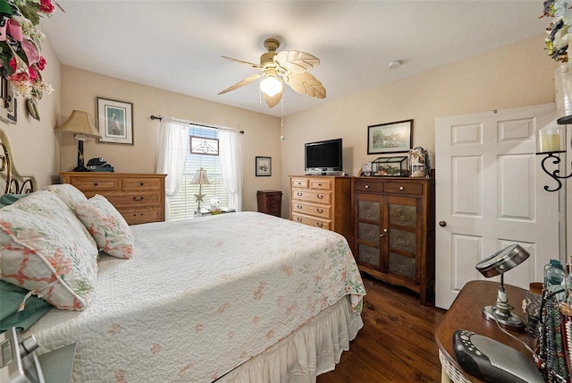 bedroom with a ceiling fan and dark wood-type flooring