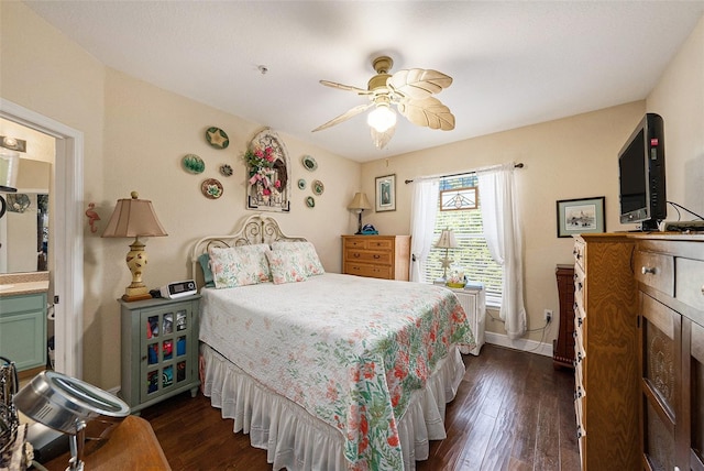 bedroom with dark wood-style flooring, ceiling fan, and baseboards