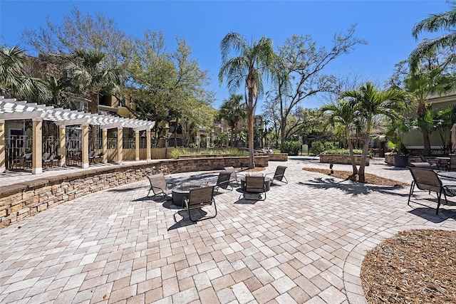 view of patio featuring an outdoor fire pit and a pergola