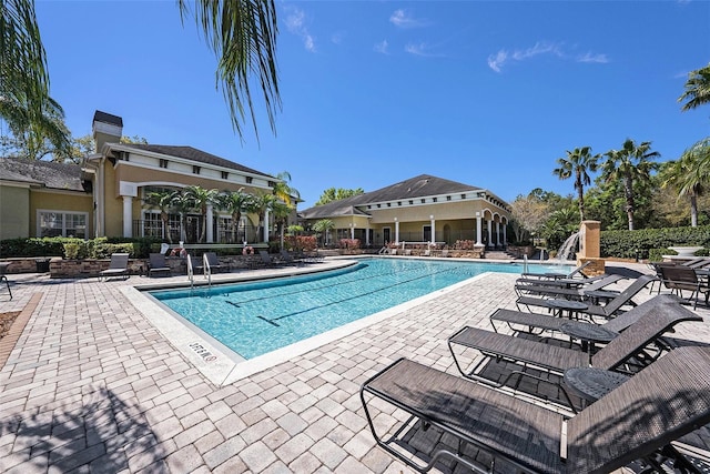 community pool with a patio area