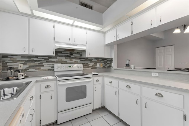 kitchen featuring visible vents, electric range, light countertops, under cabinet range hood, and tasteful backsplash