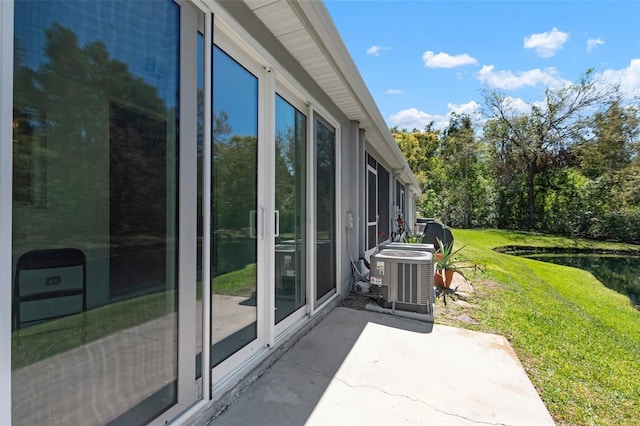 exterior space with a water view and central AC