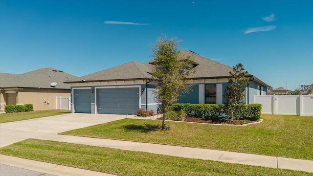 view of front of property featuring driveway, fence, a front yard, a shingled roof, and an attached garage