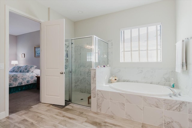 full bathroom featuring a bath, wood finished floors, a stall shower, and connected bathroom