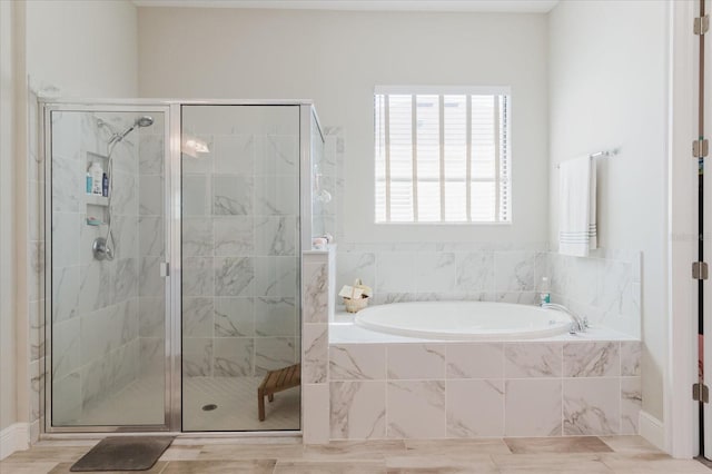 bathroom with a bath and a shower stall