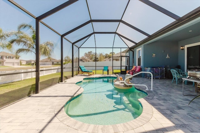 view of pool with a fenced in pool, a patio, glass enclosure, and fence