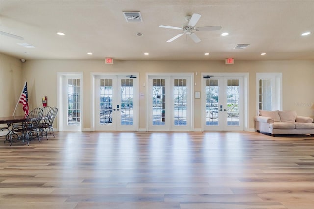 interior space featuring visible vents, recessed lighting, french doors, and light wood-type flooring