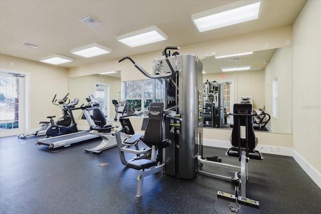 exercise room with visible vents and baseboards