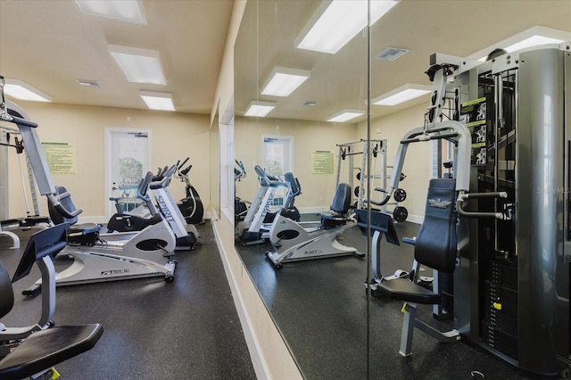 gym with baseboards and visible vents