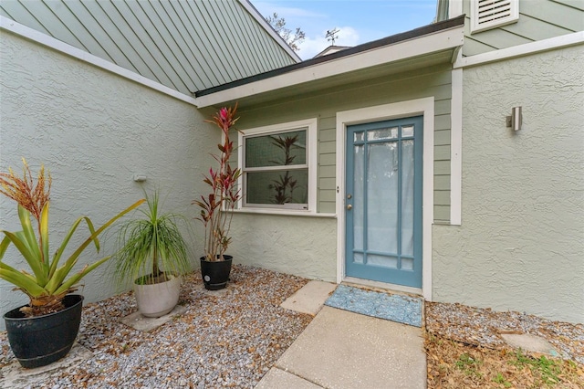 property entrance with stucco siding