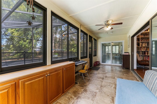 sunroom with ceiling fan and a healthy amount of sunlight