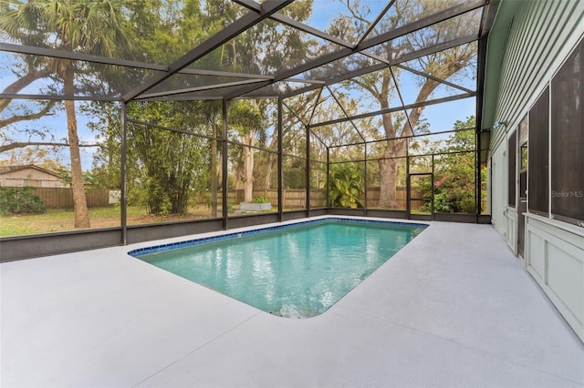 outdoor pool with a lanai, a patio area, and a fenced backyard