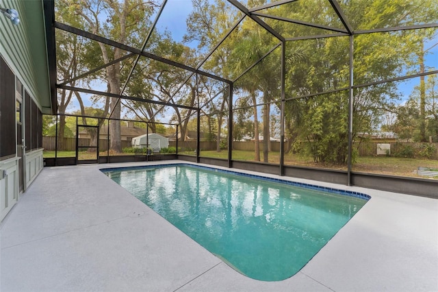 pool with a patio area and glass enclosure