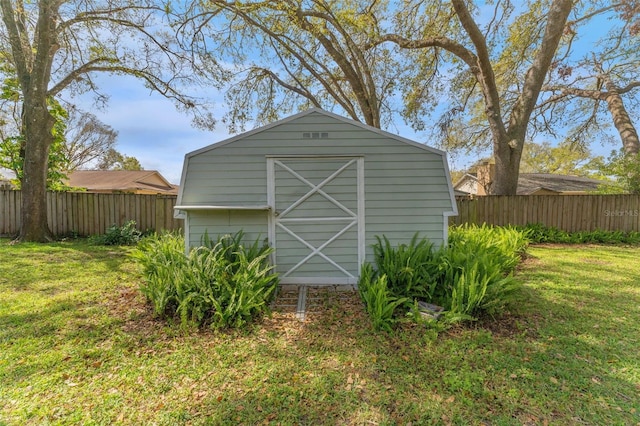 view of shed featuring fence