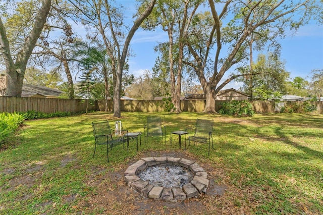 view of yard featuring an outdoor fire pit and a fenced backyard