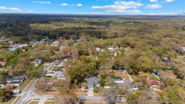 drone / aerial view featuring a wooded view