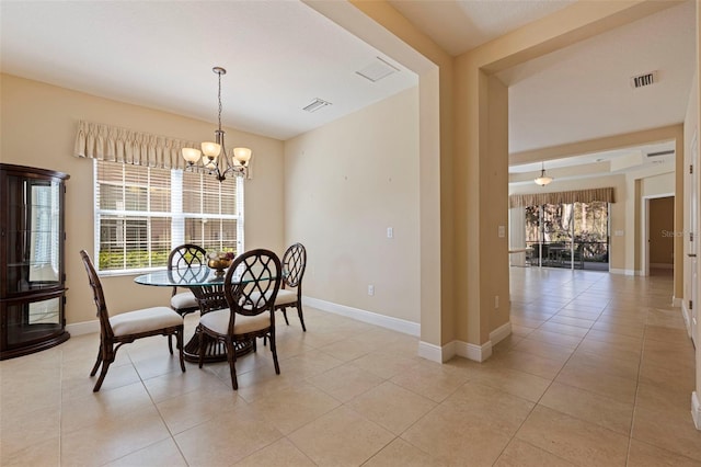 dining room featuring baseboards, visible vents, and a notable chandelier