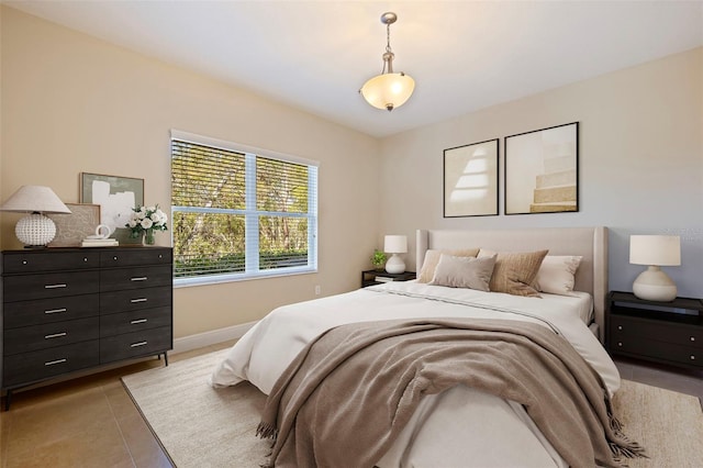 bedroom featuring baseboards and light tile patterned floors