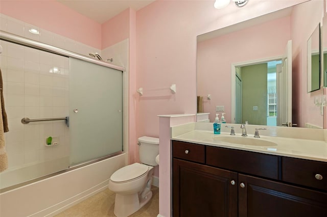 full bathroom with vanity, shower / bath combination with glass door, tile patterned flooring, and toilet