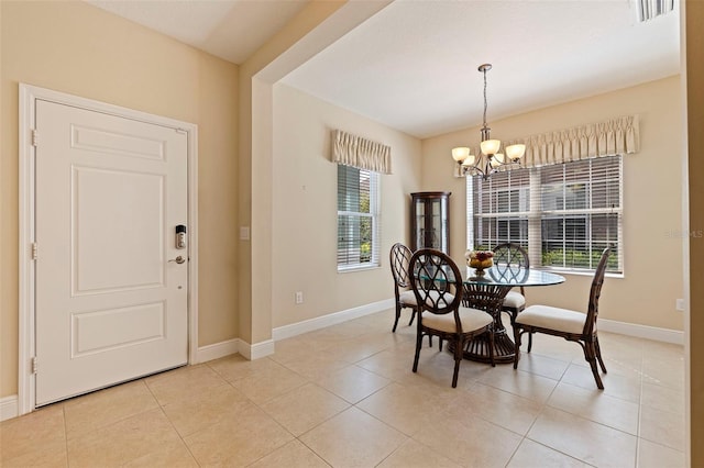 dining room featuring light tile patterned floors, visible vents, baseboards, and an inviting chandelier