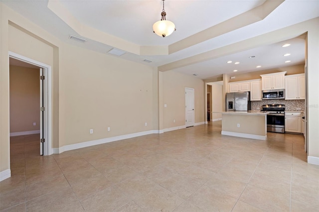 unfurnished living room featuring recessed lighting, baseboards, visible vents, a tray ceiling, and light tile patterned flooring