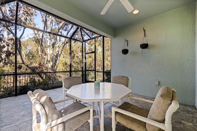 sunroom with a ceiling fan