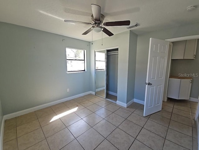 unfurnished bedroom with visible vents, baseboards, and light tile patterned floors