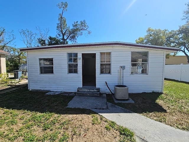 bungalow-style home with entry steps, fence, and a front yard