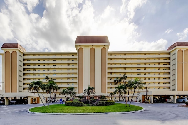 view of building exterior with covered parking