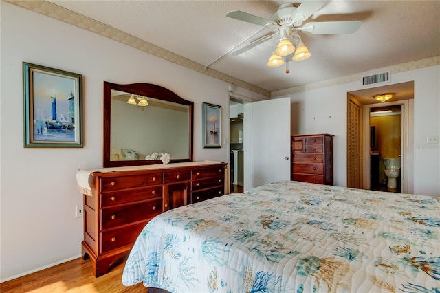 bedroom featuring a ceiling fan, a closet, visible vents, and wood finished floors