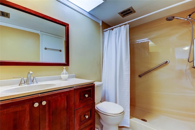 bathroom featuring toilet, a stall shower, vanity, and visible vents