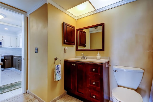 half bathroom featuring toilet, vanity, decorative backsplash, and tile patterned floors