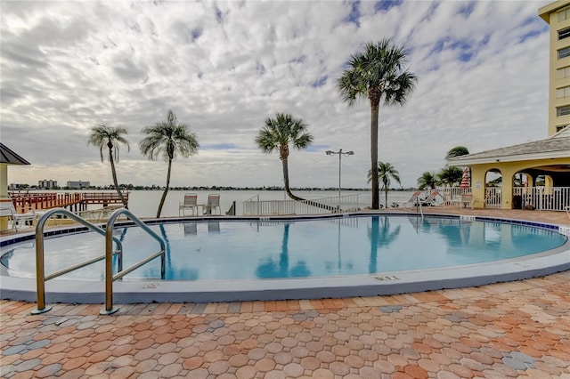 view of swimming pool featuring fence