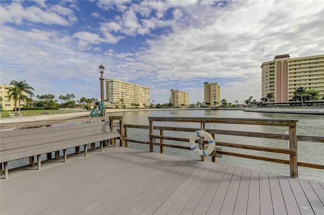 view of dock with a view of city and a water view