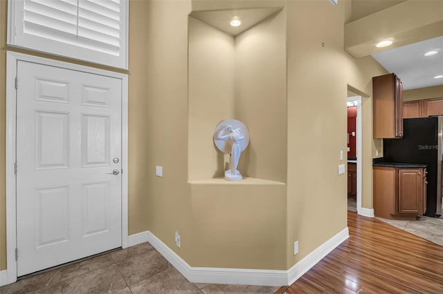 foyer with light tile patterned floors, recessed lighting, and baseboards