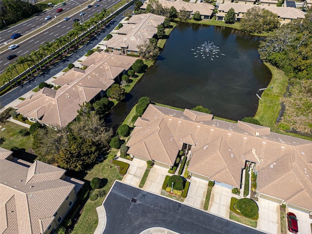 birds eye view of property with a water view and a residential view