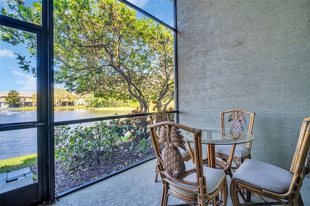 unfurnished sunroom with a water view