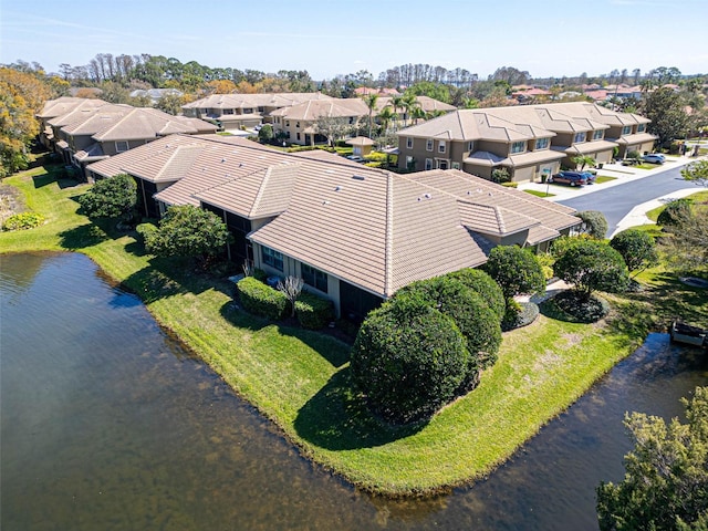 drone / aerial view featuring a water view and a residential view