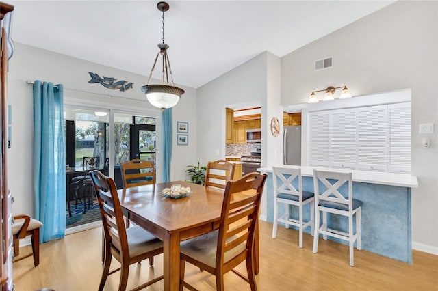 11430 94th St, Largo, FL 33773 - dining space featuring lofted ceiling, visible vents, and light wood-type flooring