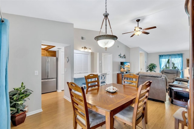 11430 94th St, Largo, FL 33773 - dining room with visible vents, baseboards, ceiling fan, lofted ceiling, and light wood-type flooring
