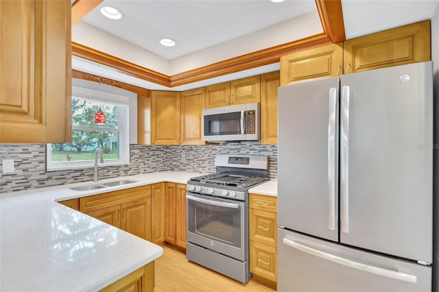 11430 94th St, Largo, FL 33773 - kitchen featuring backsplash, light countertops, a sink, and appliances with stainless steel finishes