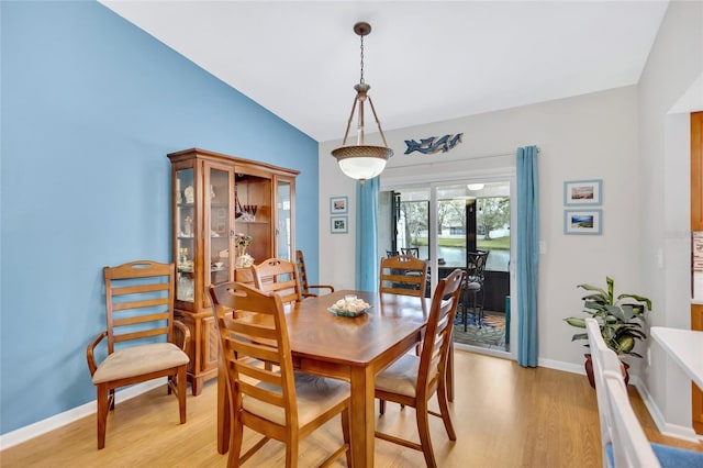 11430 94th St, Largo, FL 33773 - dining area featuring baseboards, vaulted ceiling, and light wood-type flooring